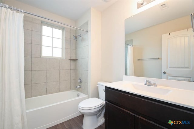 full bathroom featuring hardwood / wood-style flooring, toilet, shower / bath combination with curtain, and vanity