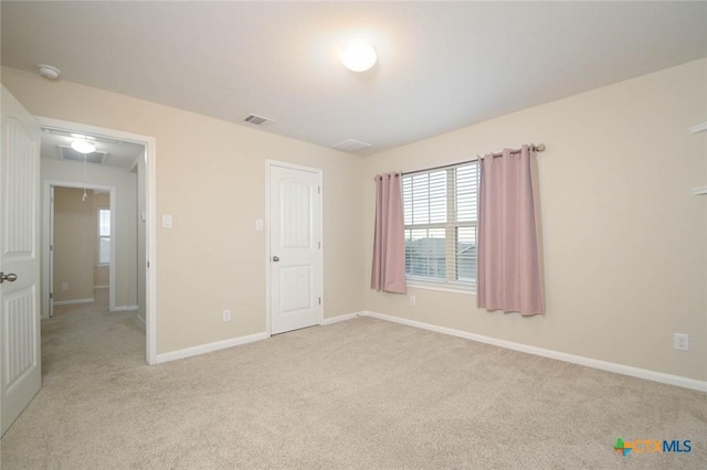 unfurnished bedroom featuring light carpet