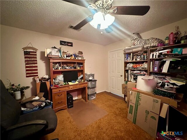 carpeted office space with visible vents, a textured ceiling, and ceiling fan