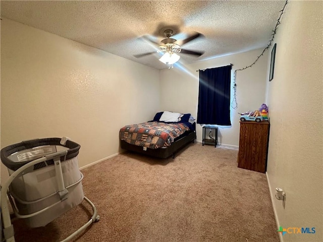 bedroom featuring carpet floors, a textured ceiling, baseboards, and ceiling fan