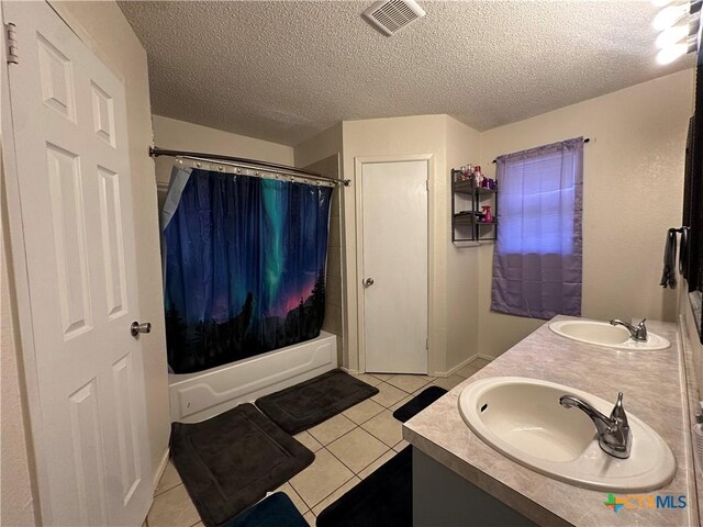 bathroom featuring tile patterned flooring, a sink, and visible vents
