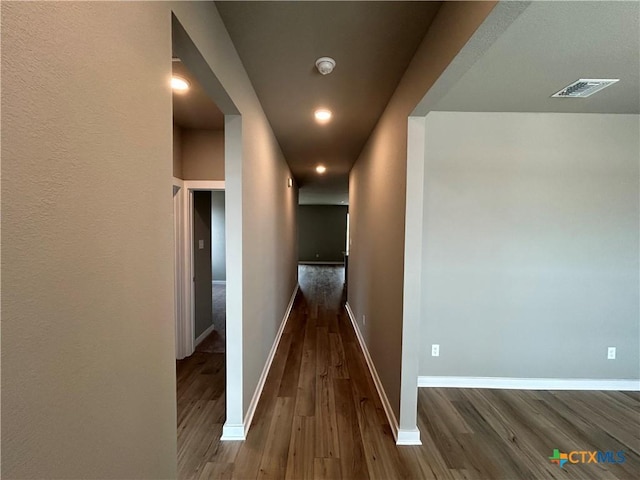 hall with dark hardwood / wood-style flooring