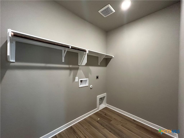 washroom featuring electric dryer hookup, hookup for a washing machine, hookup for a gas dryer, and dark hardwood / wood-style floors