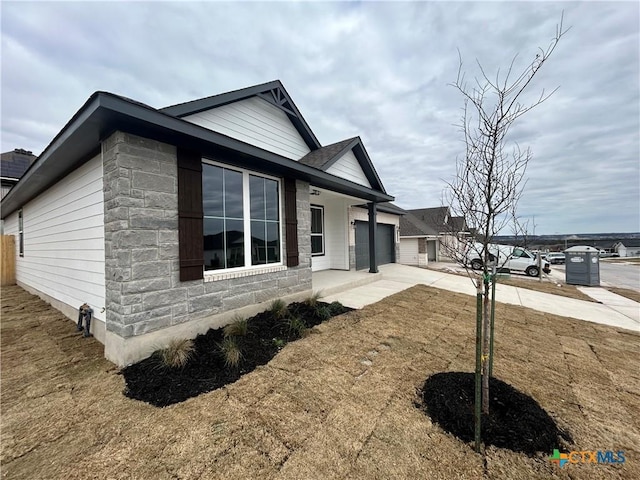 view of home's exterior with a garage and a lawn