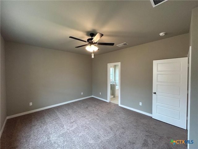 unfurnished bedroom with dark carpet and ensuite bath