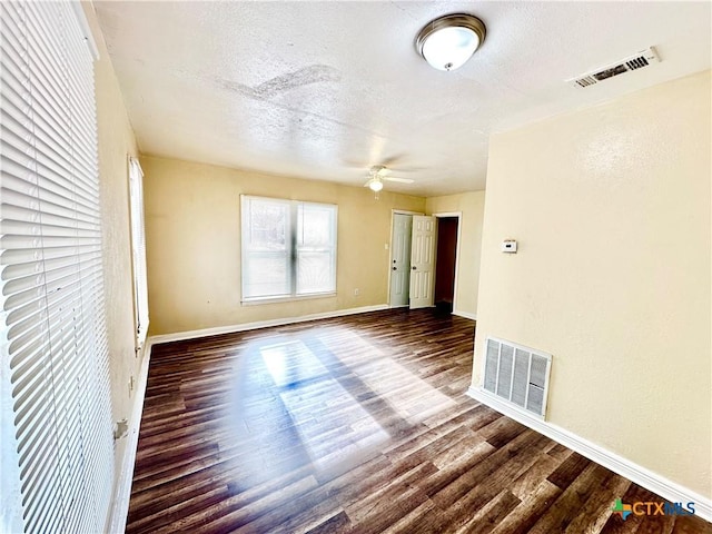 unfurnished room featuring hardwood / wood-style flooring, ceiling fan, and a textured ceiling