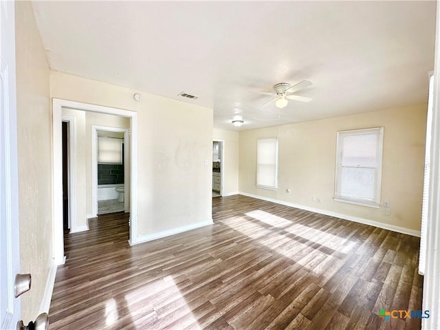 unfurnished room with ceiling fan and dark wood-type flooring