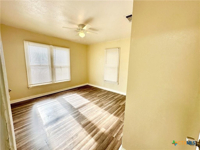 unfurnished room featuring ceiling fan and hardwood / wood-style flooring