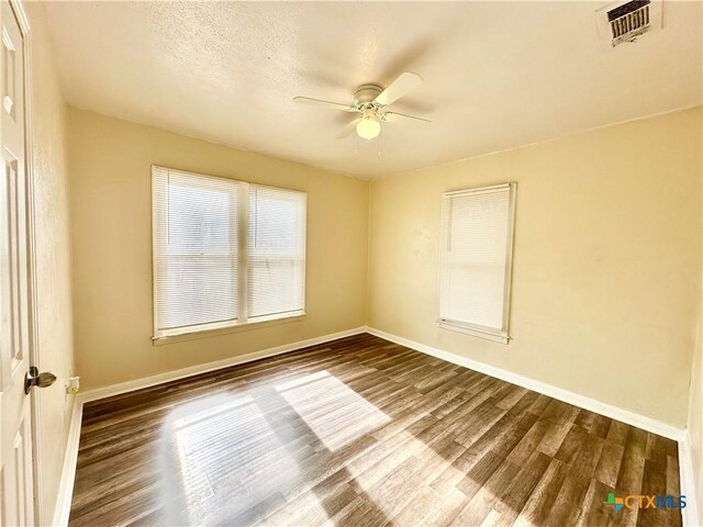 empty room featuring ceiling fan and wood-type flooring