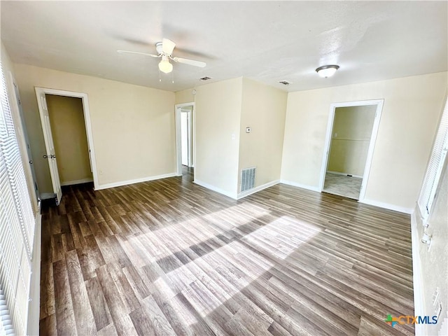 unfurnished room with ceiling fan and dark hardwood / wood-style flooring