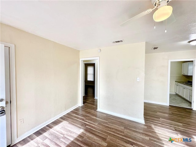 unfurnished room with hardwood / wood-style flooring and ceiling fan