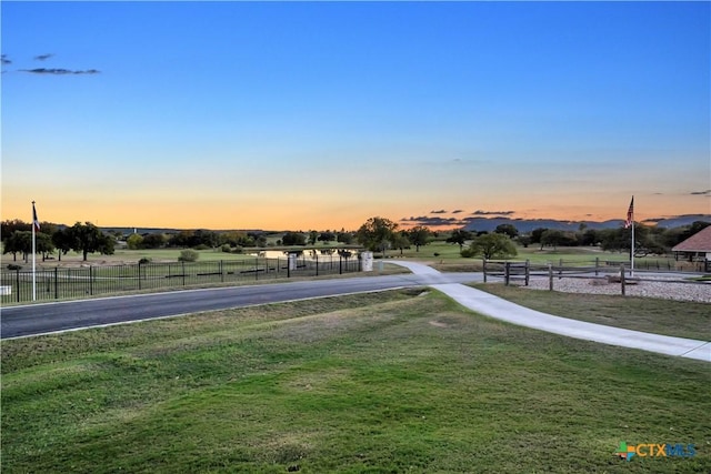 view of community with a yard and a rural view