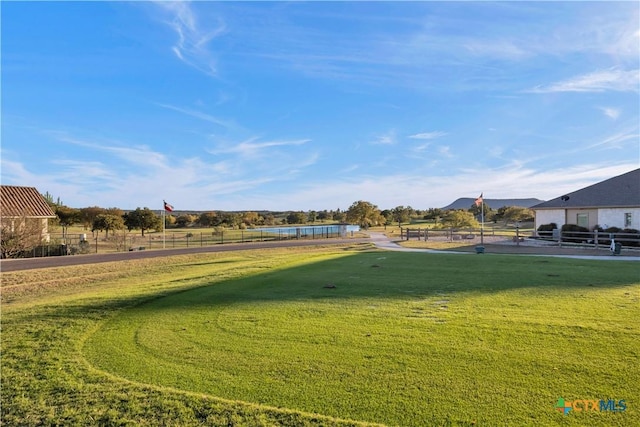 view of property's community with a lawn