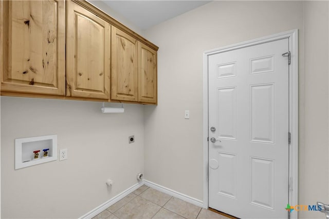 washroom featuring cabinets, hookup for a washing machine, hookup for an electric dryer, and light tile patterned flooring