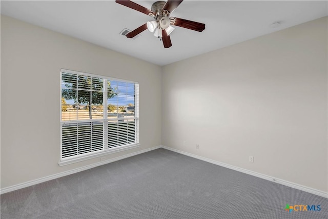 spare room featuring carpet floors and ceiling fan