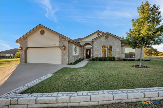 ranch-style house featuring a garage and a front yard