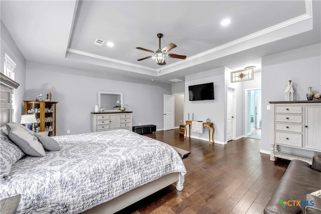 bedroom featuring a raised ceiling, ceiling fan, dark hardwood / wood-style floors, and ornamental molding