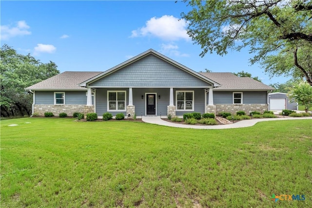 craftsman inspired home with an outbuilding and a front lawn