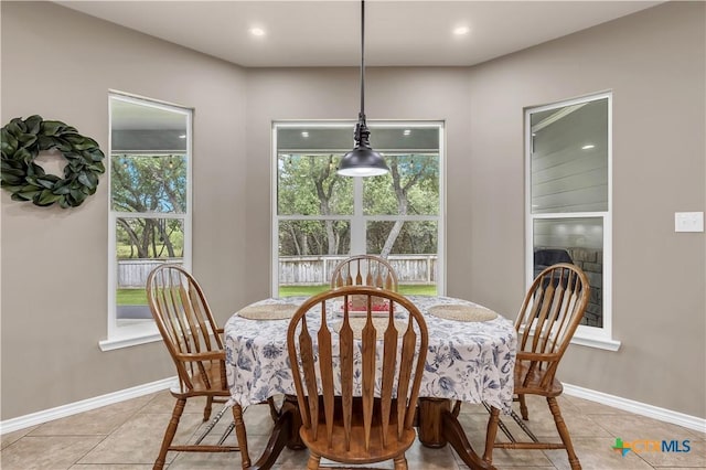 dining room with light tile patterned flooring and a wealth of natural light