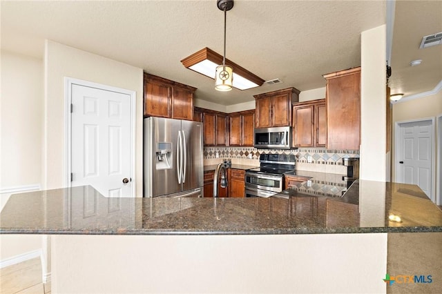 2006 Jesse Dr, Copperas Cove, TX 76522 - kitchen with backsplash, appliances with stainless steel finishes, dark stone counters, and visible vents