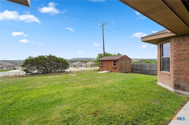2006 Jesse Dr, Copperas Cove, TX 76522 - view of yard featuring an outdoor structure, a fenced backyard, and a storage unit