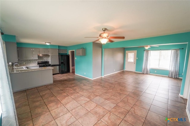 103 Royal Dr, Victoria, TX 77901 - unfurnished living room with ceiling fan, light tile patterned flooring, baseboards, and a sink