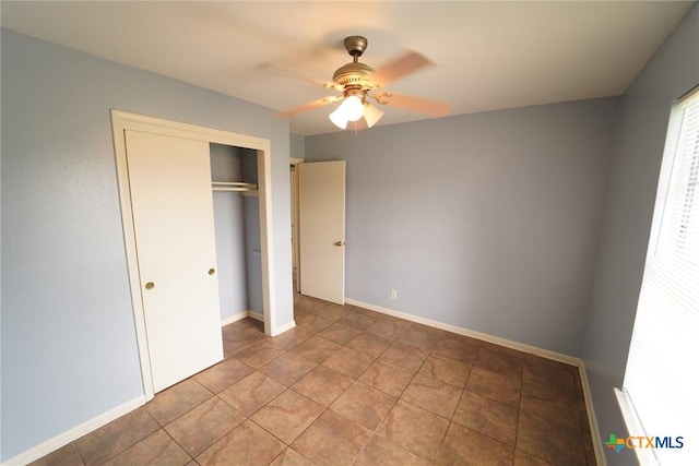 103 Royal Dr, Victoria, TX 77901 - unfurnished bedroom featuring a closet, a ceiling fan, tile patterned flooring, and baseboards