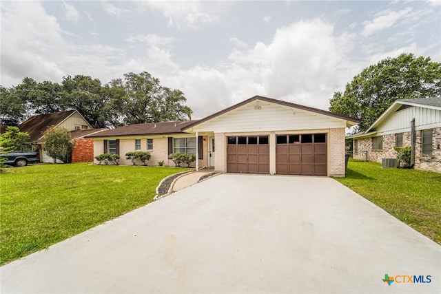 103 Royal Dr, Victoria, TX 77901 - ranch-style home with a garage, concrete driveway, a front lawn, and brick siding