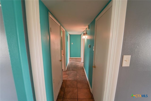 103 Royal Dr, Victoria, TX 77901 - hallway with dark tile patterned flooring and baseboards