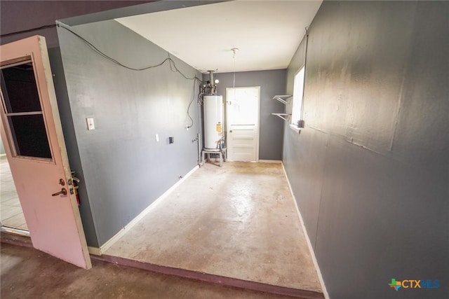 103 Royal Dr, Victoria, TX 77901 - hall with water heater, unfinished concrete flooring, and baseboards