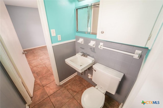 103 Royal Dr, Victoria, TX 77901 - bathroom with toilet, a sink, a wainscoted wall, and tile patterned flooring