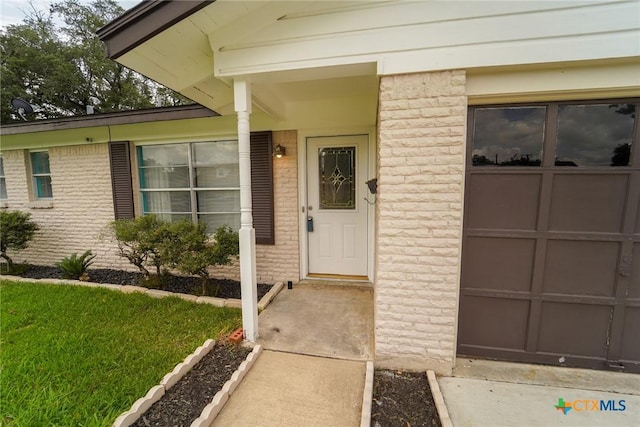 103 Royal Dr, Victoria, TX 77901 - doorway to property featuring brick siding and a garage