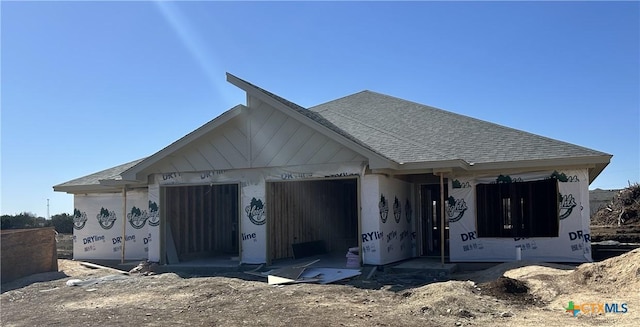 property in mid-construction featuring stucco siding, a shingled roof, and a garage