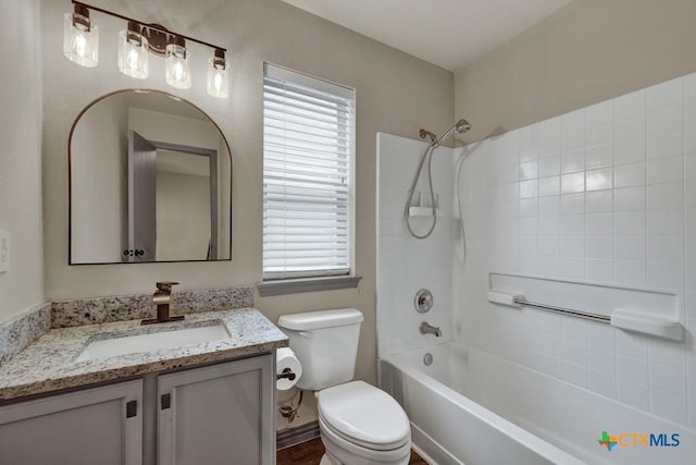 full bathroom with vanity, a wealth of natural light, toilet, and washtub / shower combination