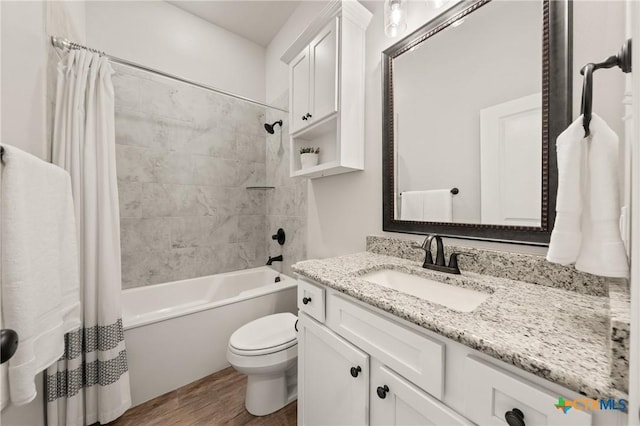 bathroom featuring toilet, shower / tub combo, wood finished floors, and vanity