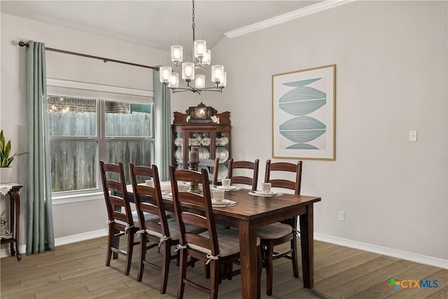 dining area featuring a wealth of natural light, light wood-type flooring, ornamental molding, and baseboards