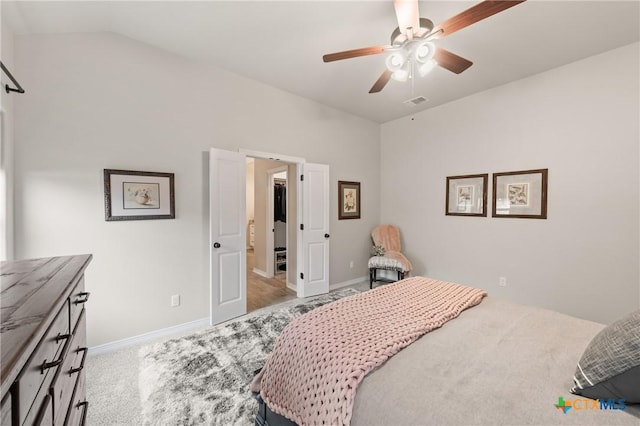 bedroom with carpet floors, visible vents, a ceiling fan, vaulted ceiling, and baseboards