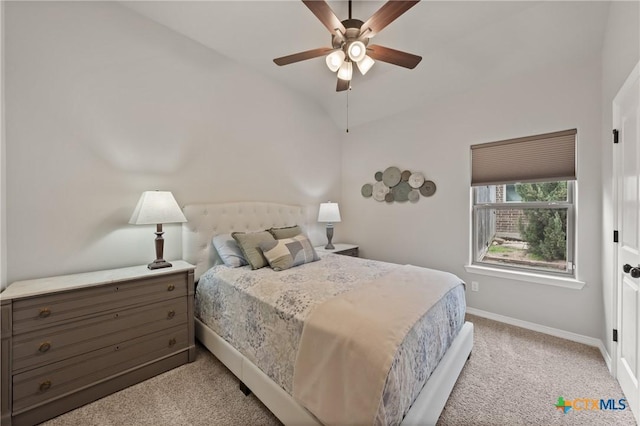 bedroom with vaulted ceiling, light carpet, a ceiling fan, and baseboards