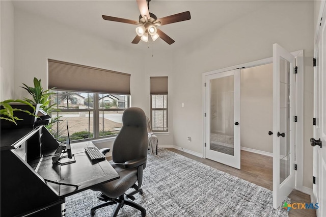 office space featuring french doors, wood finished floors, a ceiling fan, and baseboards