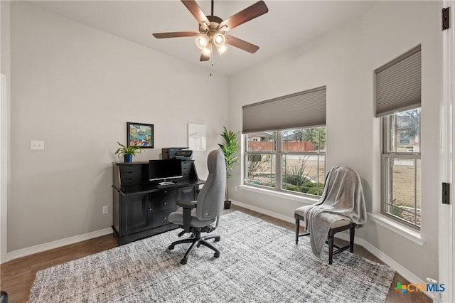 office area with a wealth of natural light, baseboards, and wood finished floors