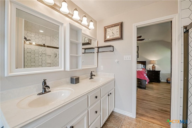 ensuite bathroom with double vanity and baseboards