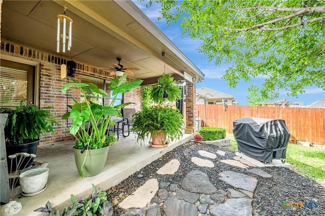 view of patio / terrace with a ceiling fan, fence, and grilling area