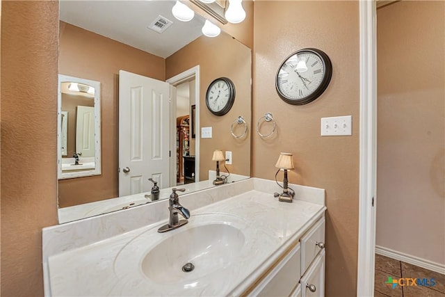 bathroom featuring tile patterned flooring and vanity