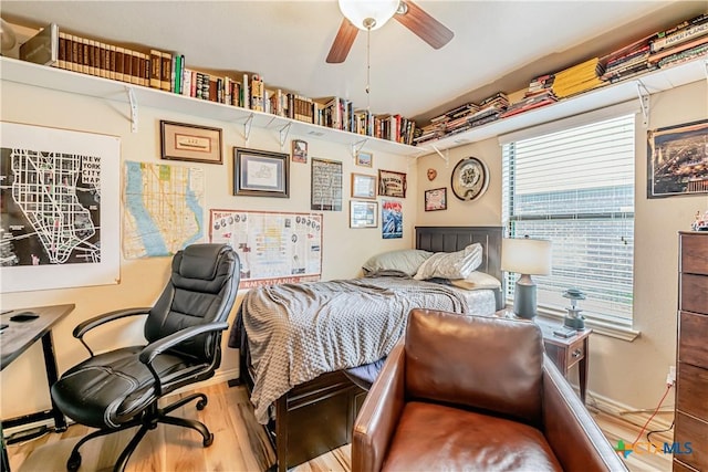 bedroom with wood finished floors, a desk, and baseboards