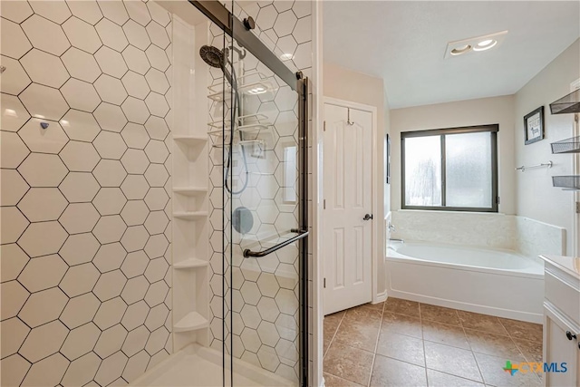 full bathroom with tile patterned floors, a shower stall, and a garden tub