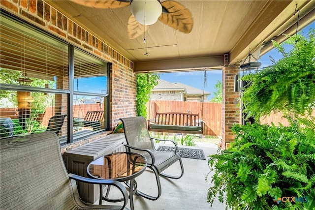 view of patio with a ceiling fan and fence