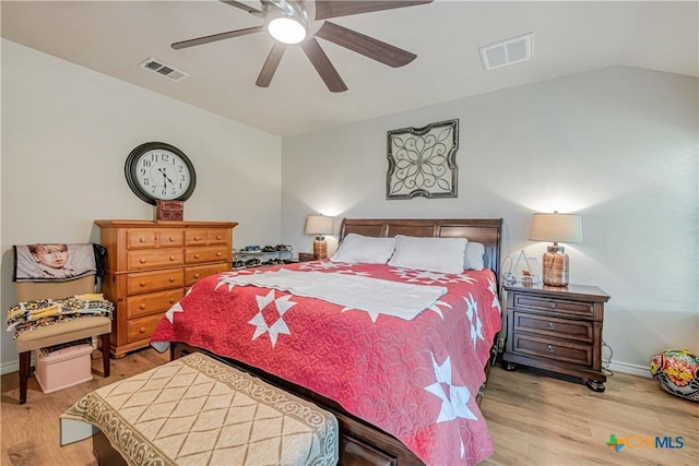 bedroom featuring light wood finished floors, baseboards, ceiling fan, and vaulted ceiling