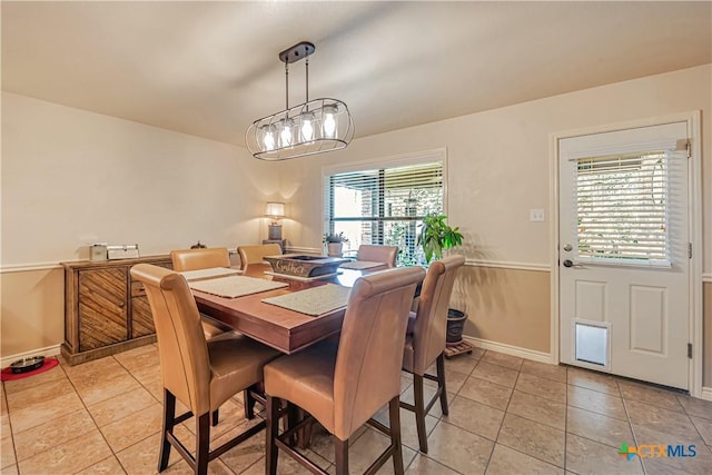 dining space with light tile patterned floors and baseboards