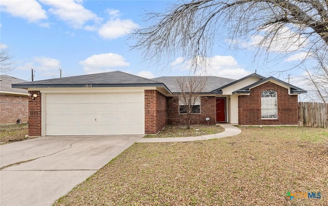 ranch-style home featuring an attached garage, brick siding, fence, driveway, and a front lawn