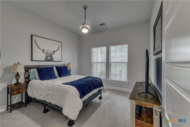3935 Outpost Trce, Lago Vista, TX 78645 - bedroom featuring baseboards, light carpet, and a ceiling fan